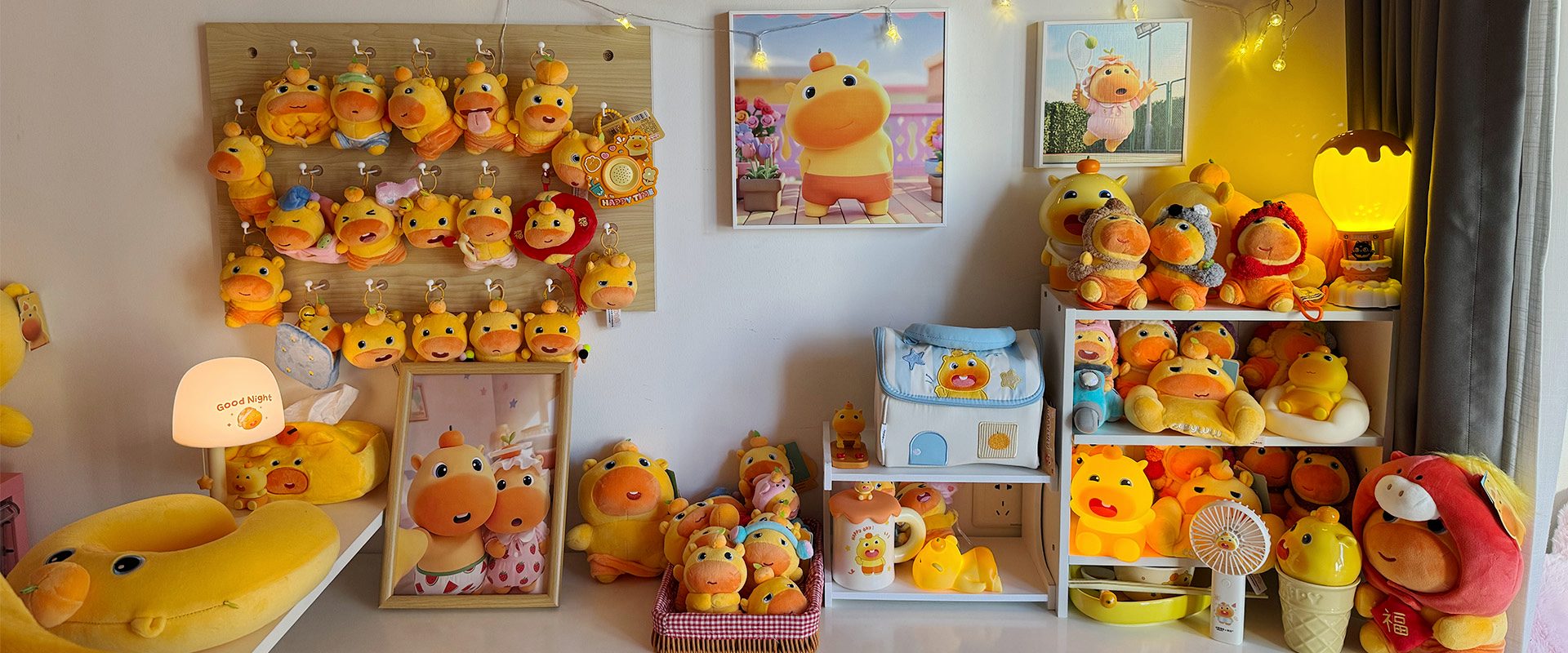 The CapyLulumi studio collection wall with Lulu and Lumi merchandise and warm lights